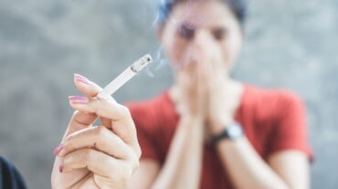 Woman sitting near a smoker