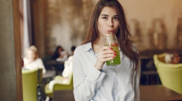A woman drinking celery juice