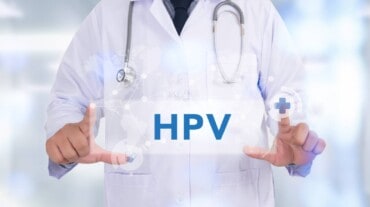 a doctor holding HPV placard.